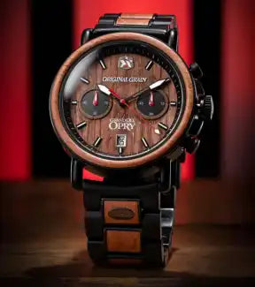 A stylish chronograph watch with a dark wood bezel and dial, black metal casing, and matching wood and metal link band.