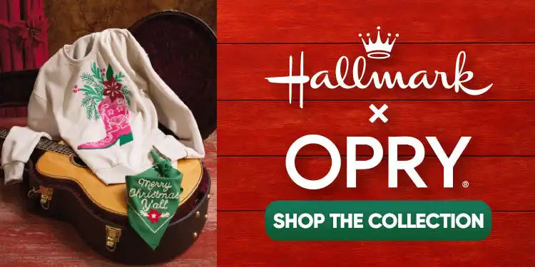 A white sweatshirt with a pink cowboy boot and festive greenery design.