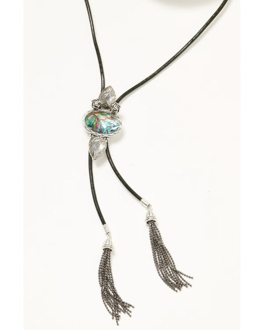 Necklace with a large central gemstone and tassels on a white background