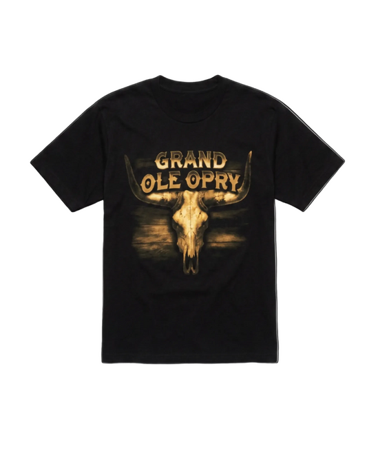 A black short-sleeve t-shirt with a graphic print featuring a bull skull and the text 'GRAND OLE OPRY' in a distressed gold font, displayed against a plain white background.