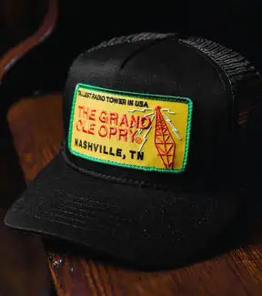 Black mesh trucker hat with ’the grand ole opry’ patch in yellow, red and green.
