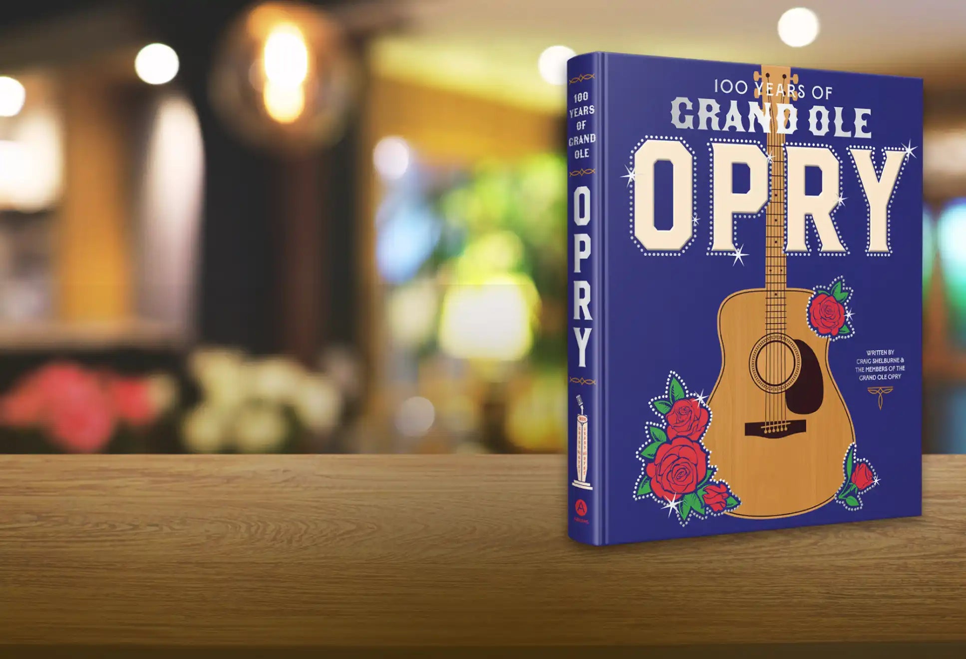 A blue hardcover book with a guitar and roses design.