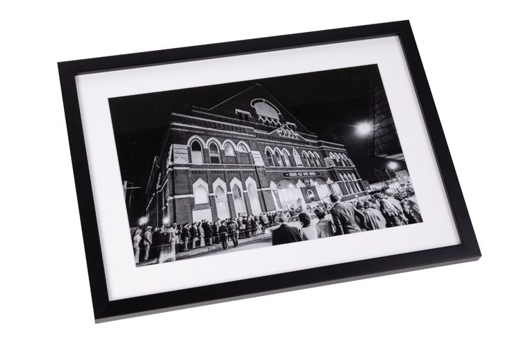 Framed Black and white Print in black frame. Exterior of The Ryman with Fans Outside