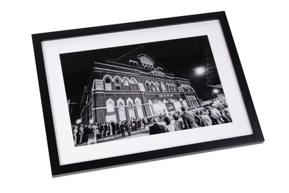 Framed Black and white Print in black frame. Exterior of The Ryman with Fans Outside
