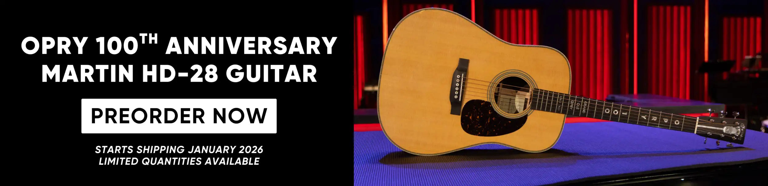 A natural wood-finish martin hd-28 acoustic guitar with a black pickguard and fretboard inlays, displayed against a red-lit stage backdrop.