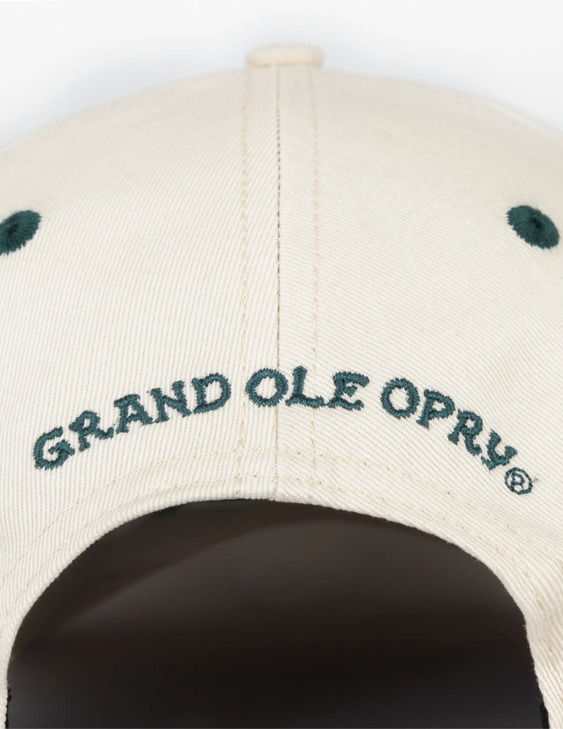Beige baseball cap with dark green embroidered grand ole opry logo and matching eyelets in opry long live country hat