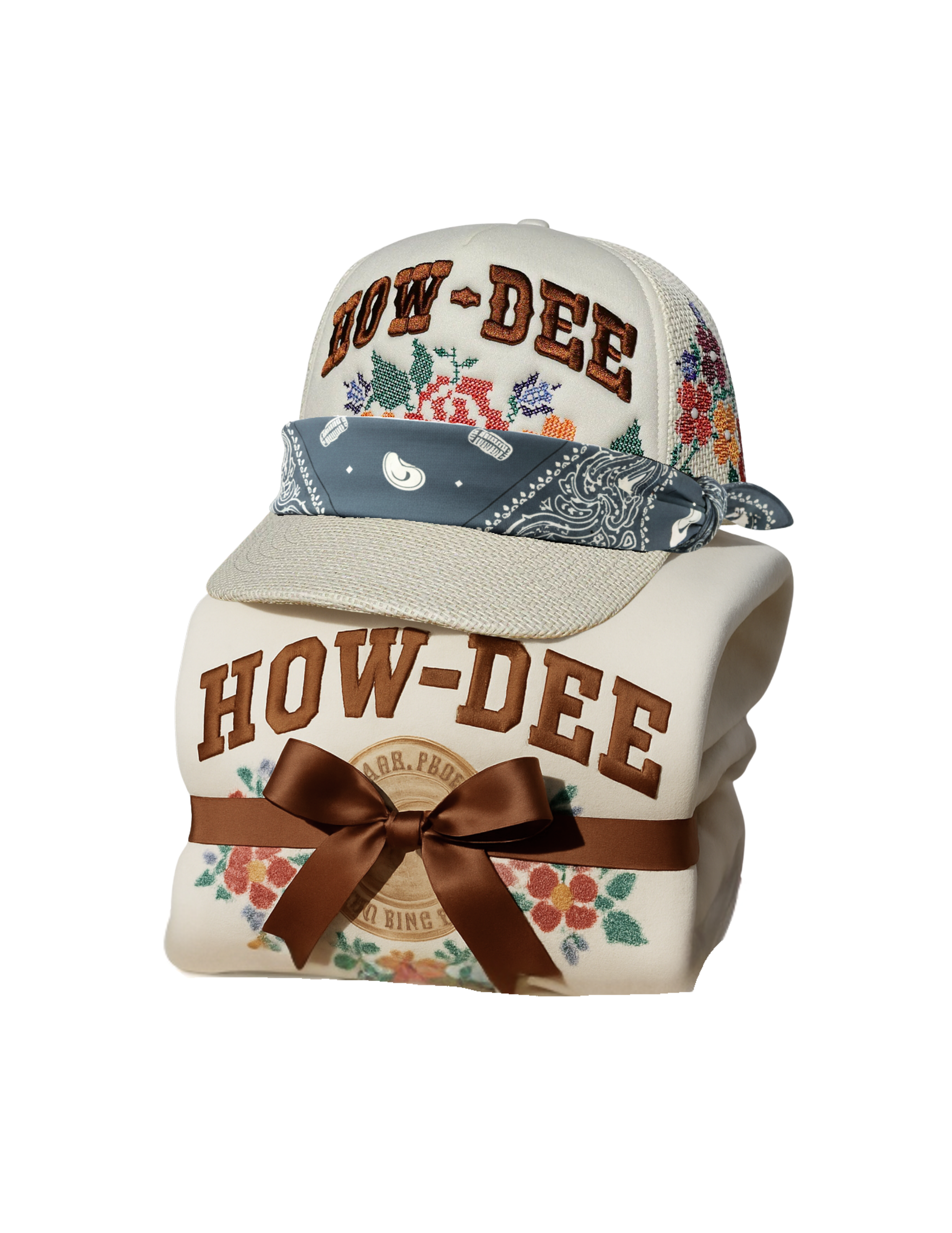 Floral-patterned cap with 'HOW-DEE' branding and a matching blanket on a white background