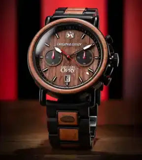 A stylish chronograph watch with a dark wood bezel and dial, black metal casing, and matching wood and metal link band.