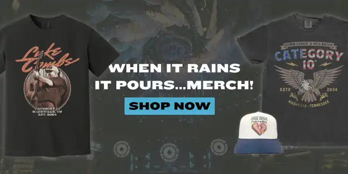 Two dark t-shirts and a baseball cap promoting a music artist.