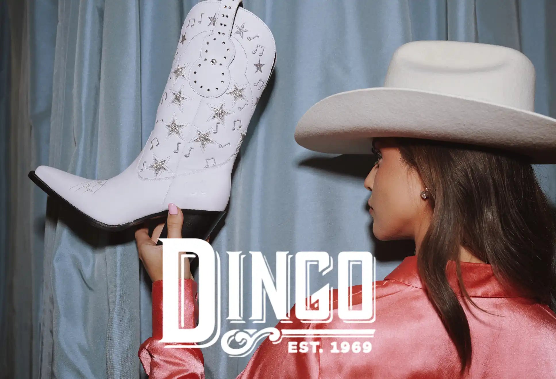 White cowboy boot with star and music note embroidery.