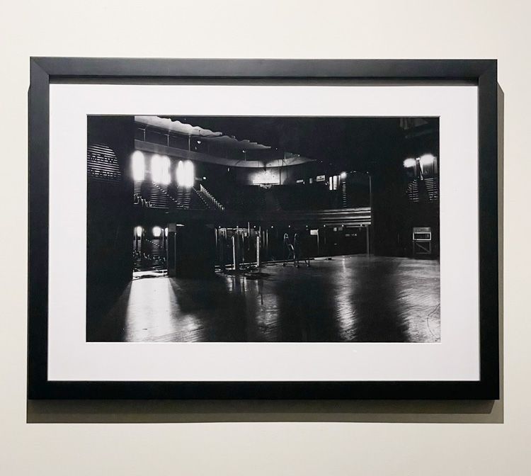 Framed Black and white Print in black frame. Back Stage at a empty Ryman on wall